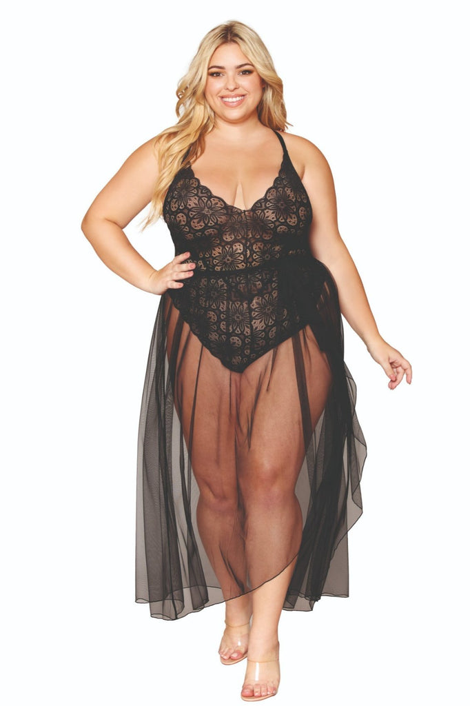 Woman modeling Fabulous Plus Size Lace Teddy and Sheer Skirt Combo, featuring a lace top, tie-front maxi skirt, and adjustable criss-cross straps.