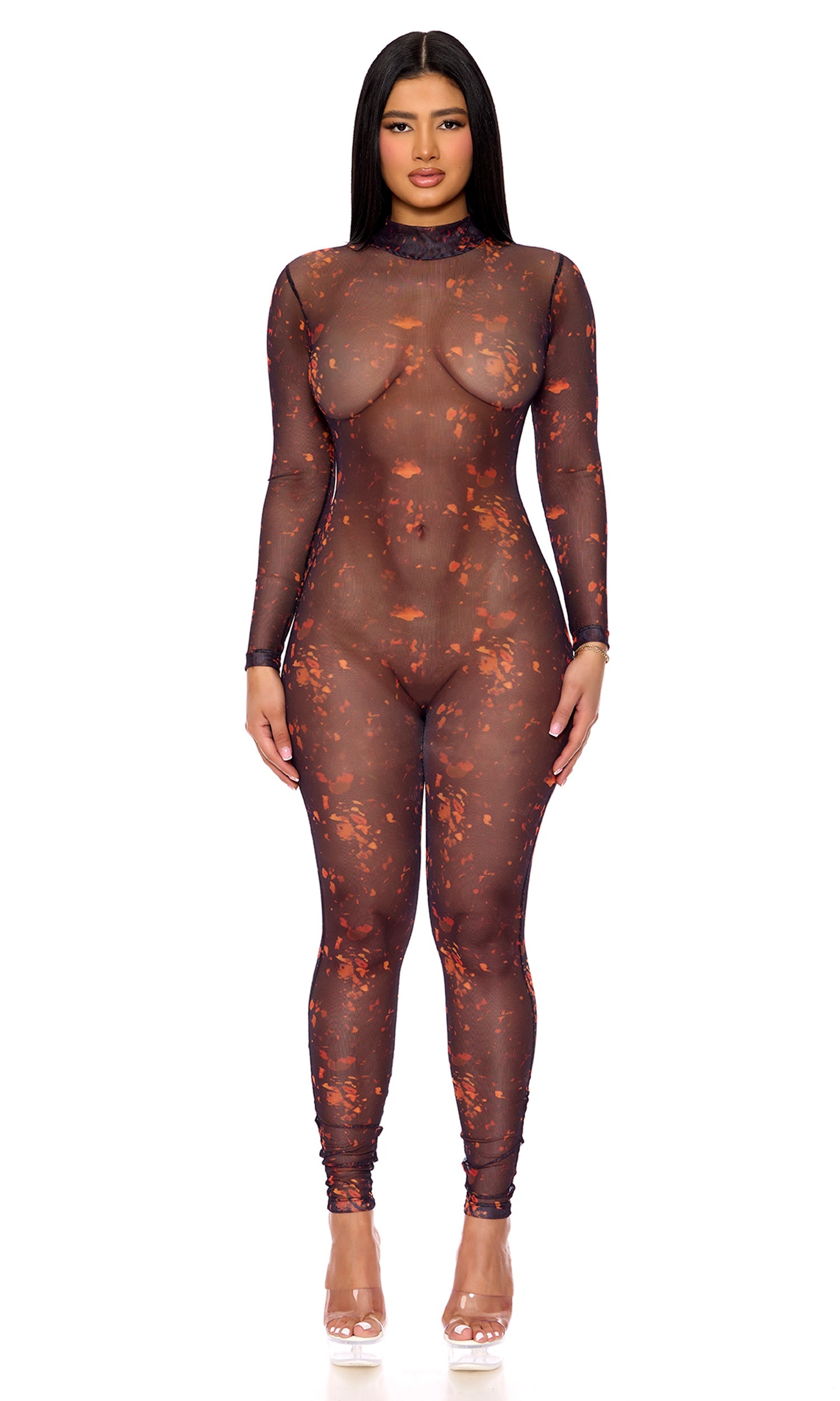 Woman wearing Erupting Lava Mesh Costume Jumpsuit with lava print, sheer mesh, mockneck, and zipback, paired with clear heels.