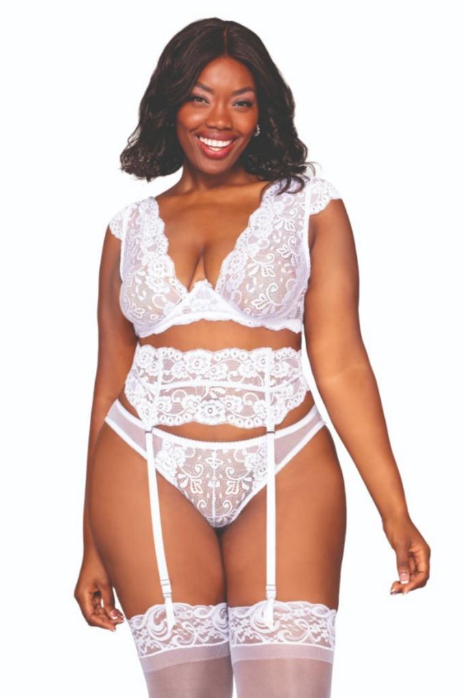 Woman modeling White Plus Size Lace Garter Set, featuring a lace bra with exposed underwire, garter belt, and keyhole back panty with ribbon accent.