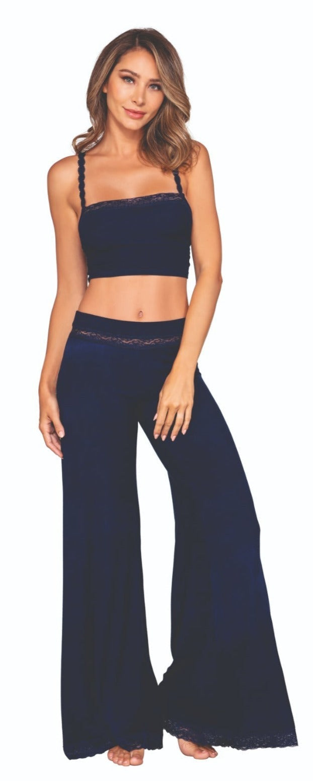 Woman modeling the Comfortable Rib Knit Jersey Sleep Pant Set, featuring a lace-detailed cami and matching wide-leg pants, ideal for a stylish, cozy night's sleep.