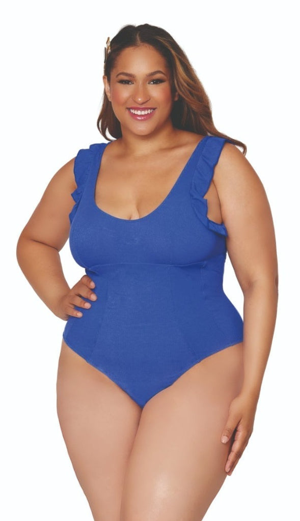 A woman with long, straight hair and a hair clip is standing and smiling with one hand on her hip, modeling the "Ruffled Sleeve Rib Knit Plus Size Teddy" in a blue shade. The background is plain white.