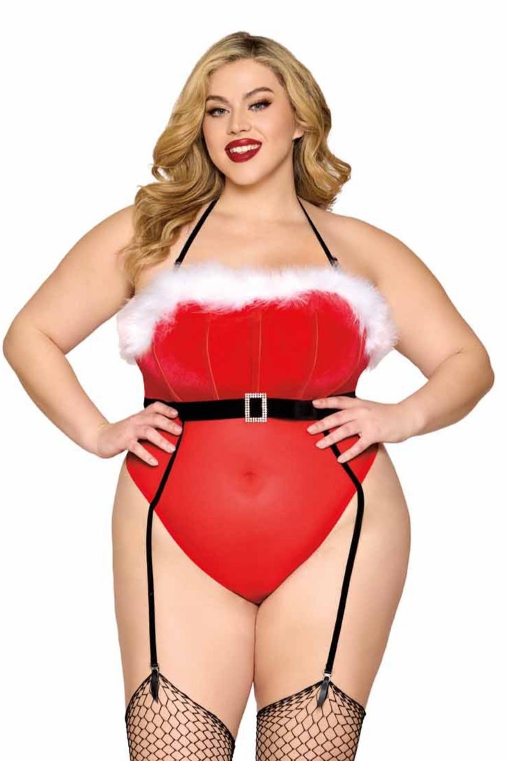 A woman models the Plus Size Velvet Santa Lingerie Teddy featuring a boned bodice, adjustable halter strap, black velvet belt, and stretch garters.