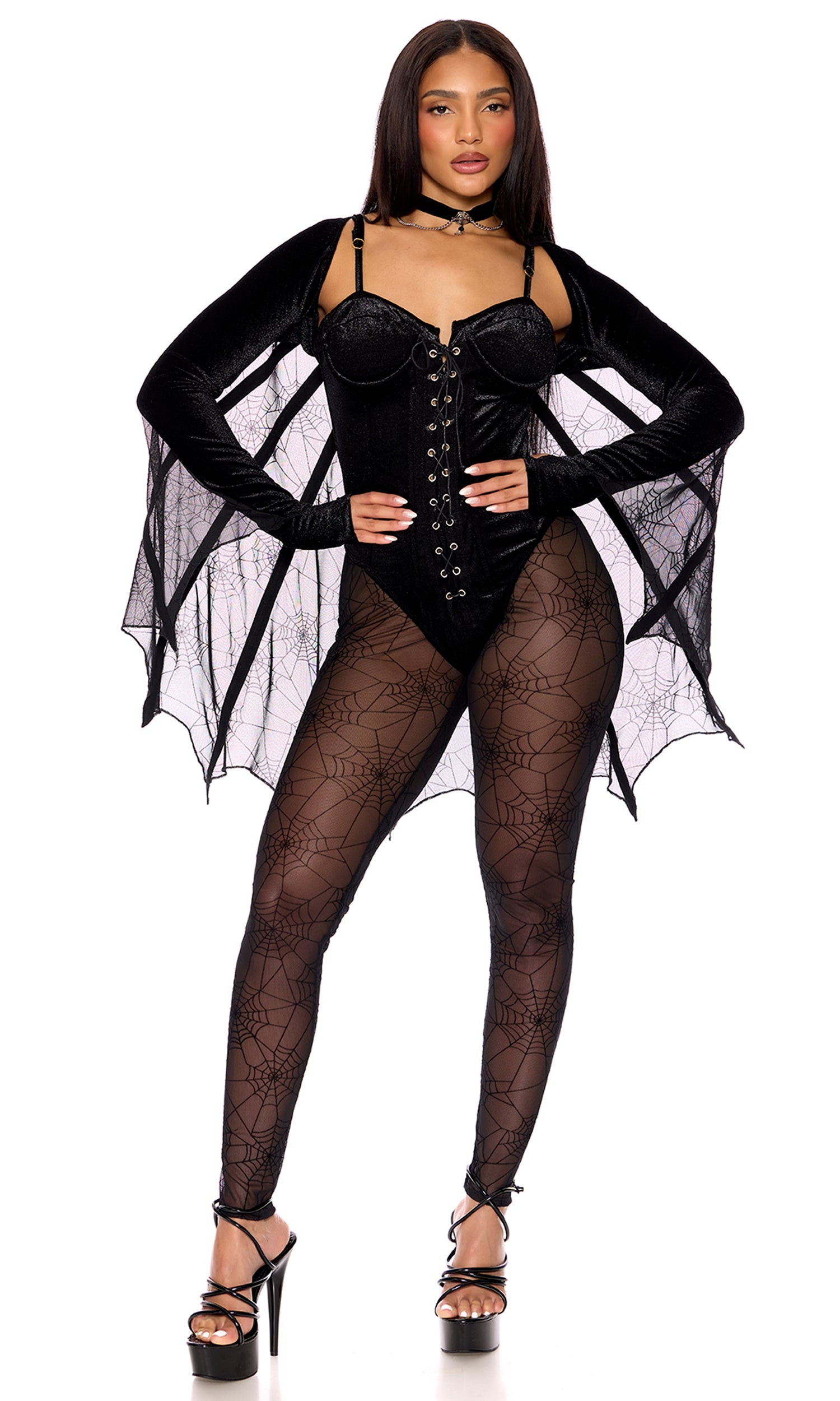 Woman wearing Mystical Spider Web Halloween Costume with velvet lace-up bodysuit, mesh cape, ornamental spider choker, and high heels.