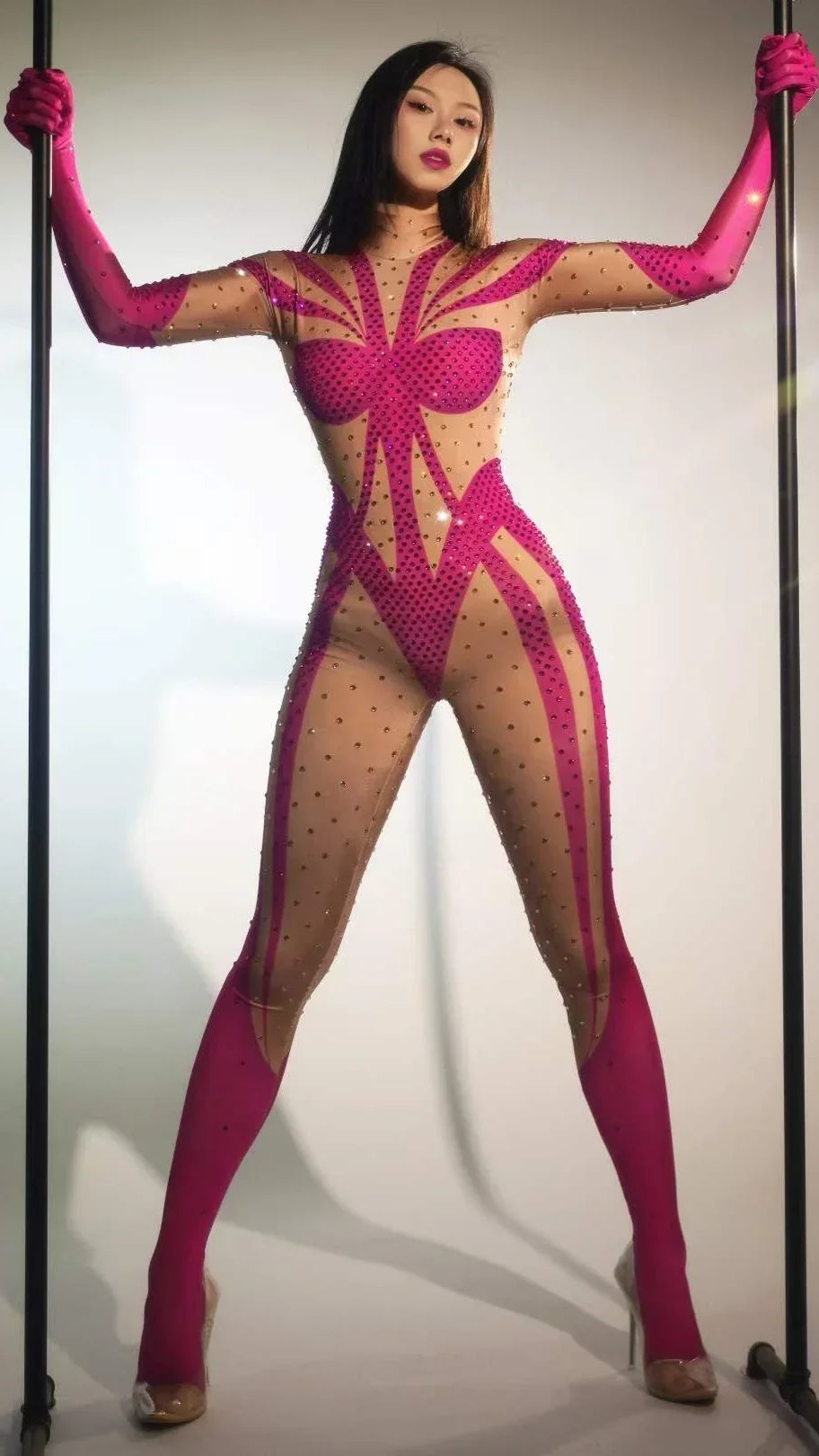 Woman in a stylish rhinestone-adorned pink outfit, suitable for DJ night clubbing, stage performances, and Mardi Gras festivals, showcasing a dance costume.