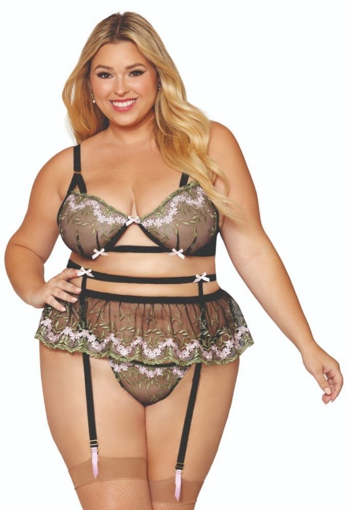 Plus Size Floral Embroidery Three Piece Lingerie Set featuring a model wearing a lace bra, ruffle skirt garter belt, and floral embroidery G-string with gold hardware.