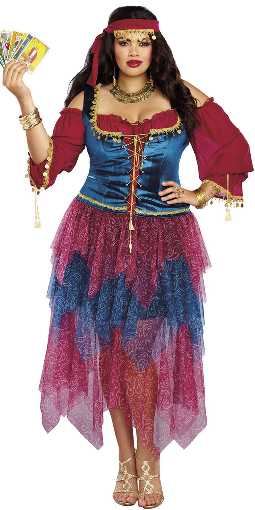 Woman wearing Sexy Plus Size Gypsy Women's Costume with a paisley skirt, velvet lace-up bodice, and gold coin details, holding a matching head wrap.